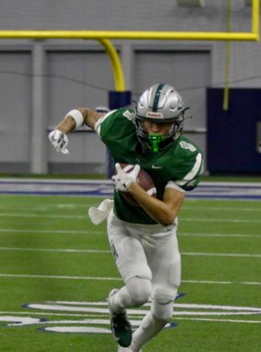 Senior Braylon Evans runs the ball for a touchdown. Evans has been a wide receiver on the varsity football team for the last three years. 